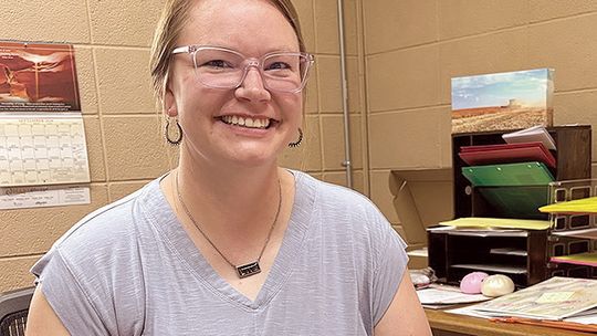 A mom Behind the desk at SMS